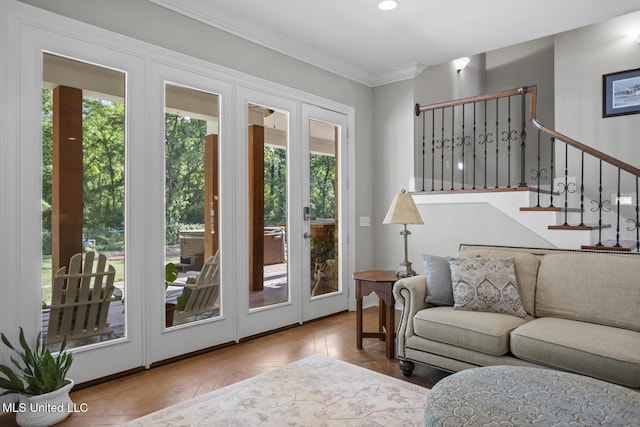 living room featuring stairway, ornamental molding, and french doors