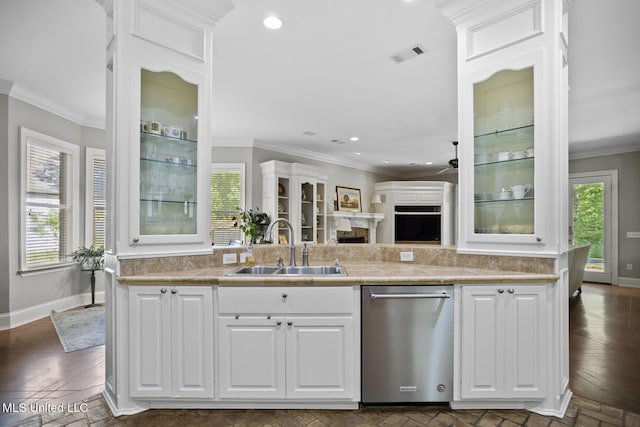 kitchen featuring stainless steel dishwasher, a sink, visible vents, white cabinetry, and light countertops