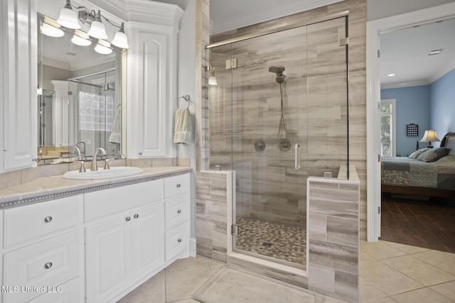 bathroom featuring tile patterned floors, a stall shower, ensuite bathroom, vanity, and ornamental molding