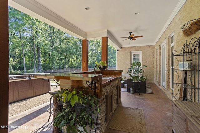exterior space featuring a hot tub, outdoor dry bar, a sink, and ceiling fan