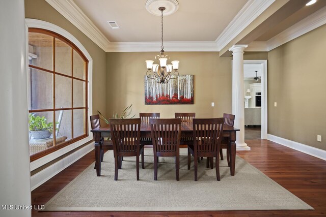 dining room featuring wood finished floors, visible vents, an inviting chandelier, and ornamental molding