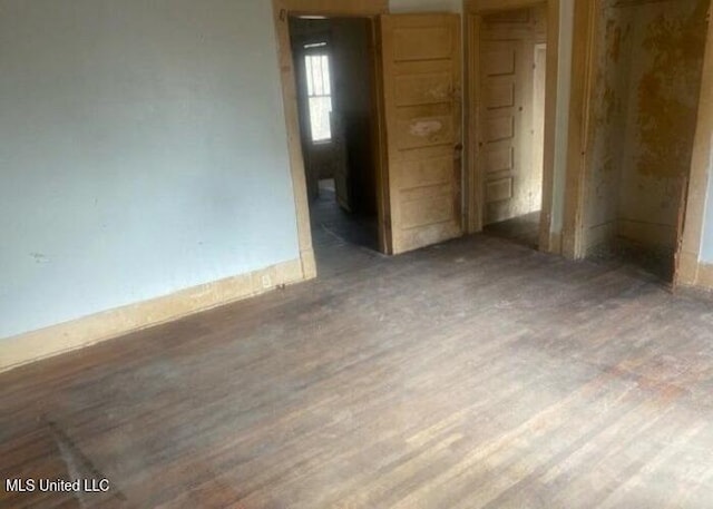 empty room with wood finished floors