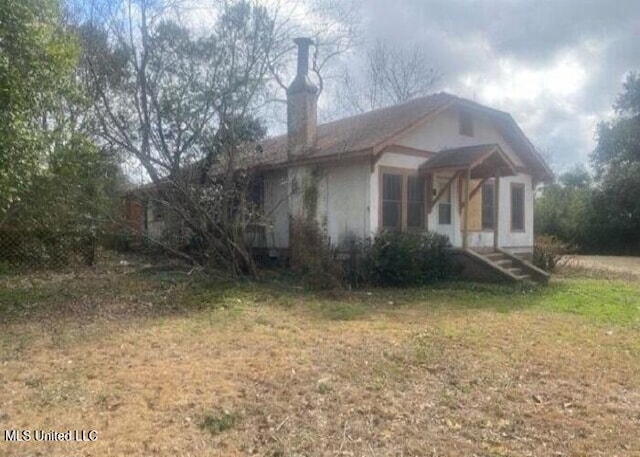 view of home's exterior with a yard