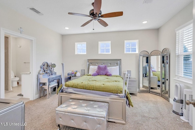 carpeted bedroom featuring connected bathroom, visible vents, recessed lighting, and a ceiling fan