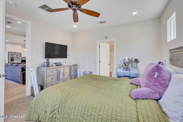 bedroom with stainless steel fridge with ice dispenser, visible vents, and recessed lighting