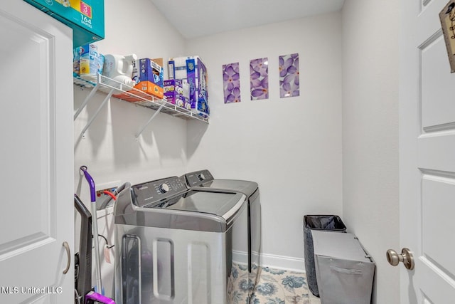 laundry area featuring washer and clothes dryer, baseboards, and laundry area