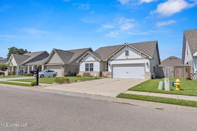view of front of house featuring fence, a garage, a front yard, a residential view, and driveway
