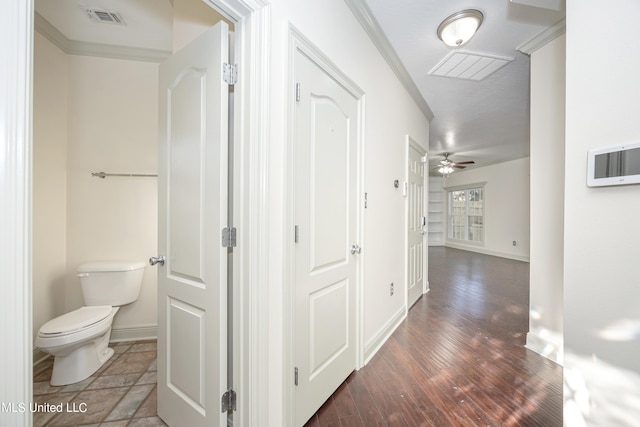 hall with ornamental molding and dark hardwood / wood-style flooring