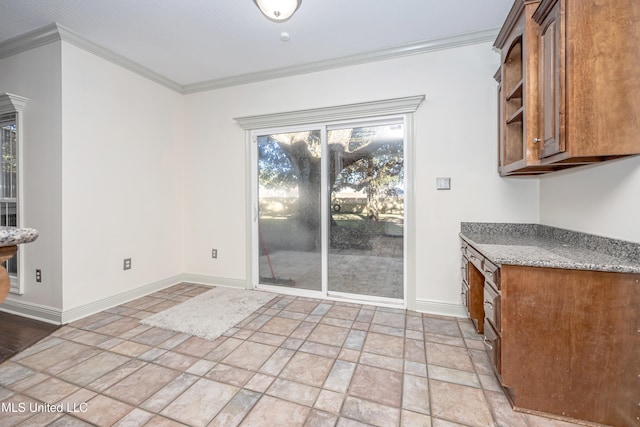 unfurnished dining area with crown molding