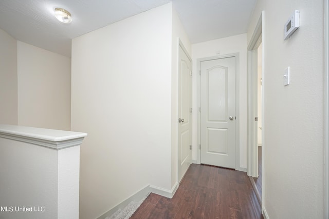 corridor featuring dark hardwood / wood-style flooring