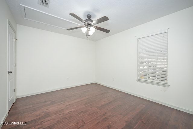 spare room featuring ceiling fan and dark hardwood / wood-style floors