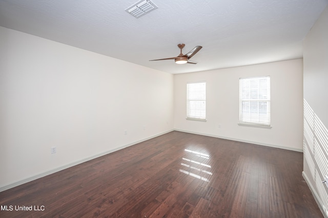 spare room featuring ceiling fan, a textured ceiling, and dark hardwood / wood-style floors