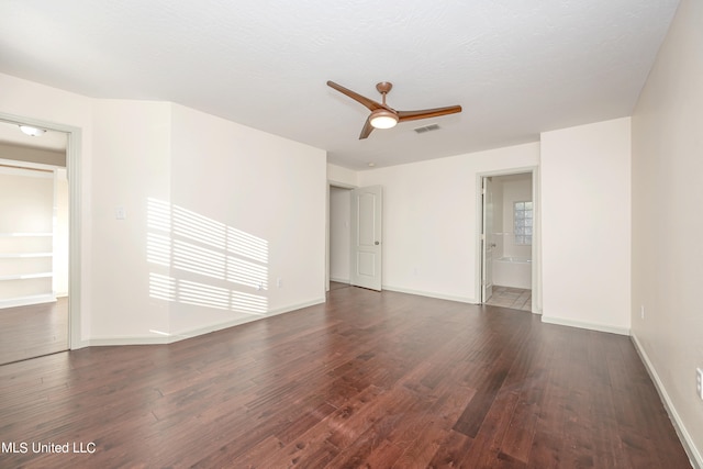 unfurnished room featuring ceiling fan, a textured ceiling, and dark hardwood / wood-style flooring