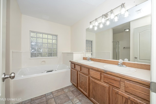 bathroom with vanity and separate shower and tub