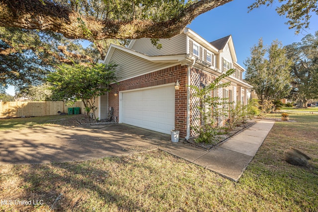 view of home's exterior featuring a garage and a lawn