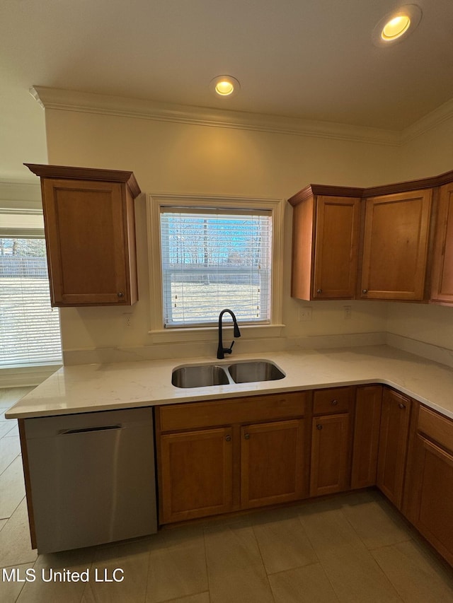 kitchen featuring dishwasher, sink, light tile patterned floors, and crown molding