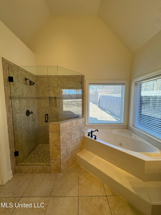 bathroom with tile patterned floors, shower with separate bathtub, and vaulted ceiling