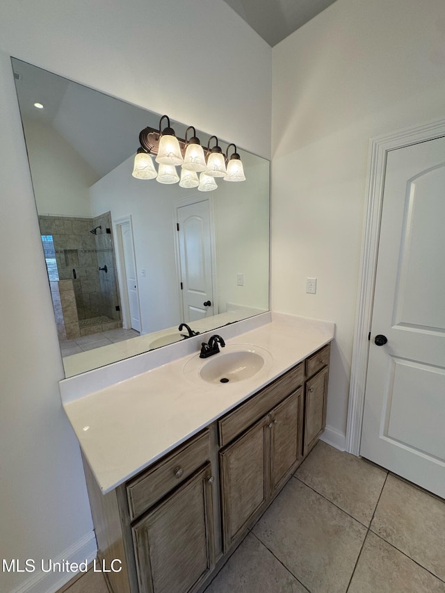 bathroom with lofted ceiling, tile patterned floors, vanity, and a shower