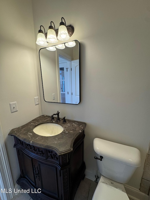 bathroom with vanity, tile patterned floors, and toilet