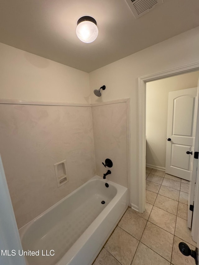 bathroom with tile patterned flooring and washtub / shower combination