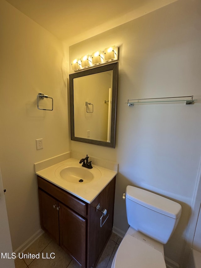 bathroom featuring tile patterned flooring, vanity, and toilet