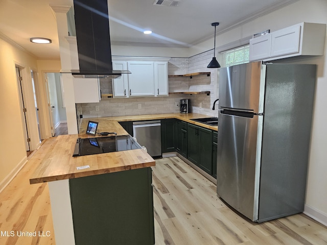 503 Brooklyn Dr, Natchez, MS 39120 - kitchen with wood counters, appliances with stainless steel finishes, island range hood, crown molding, and light wood-style floors