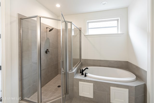 bathroom featuring separate shower and tub