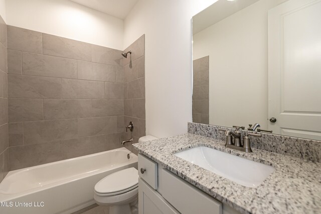 full bathroom featuring vanity, toilet, and tiled shower / bath