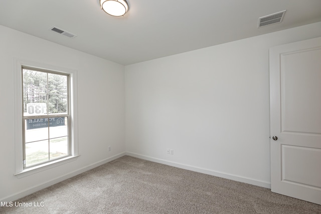 unfurnished room featuring carpet flooring and a healthy amount of sunlight