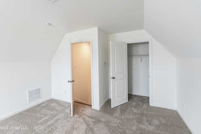 bonus room featuring vaulted ceiling and light colored carpet