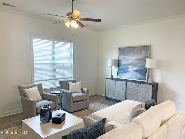 living room with crown molding, wood-type flooring, and ceiling fan