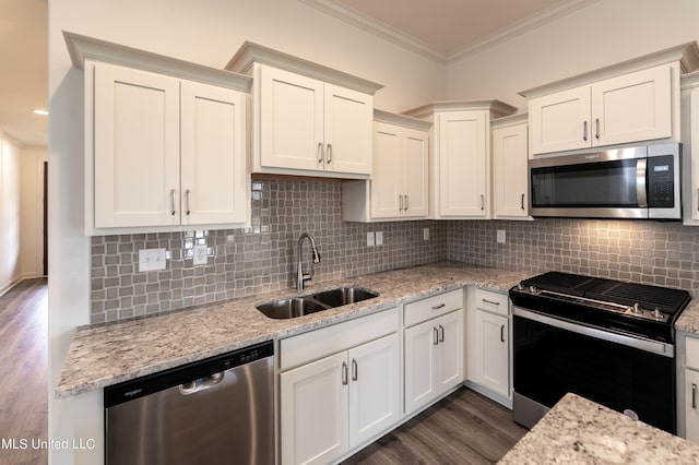 kitchen featuring dark wood-type flooring, backsplash, sink, appliances with stainless steel finishes, and light stone counters