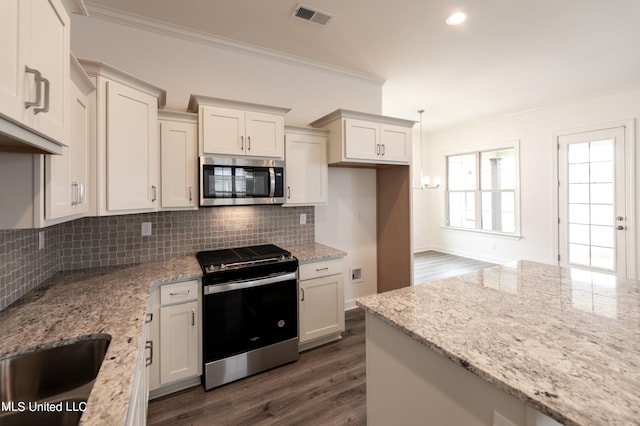 kitchen with decorative backsplash, dark wood-type flooring, stainless steel appliances, crown molding, and light stone countertops