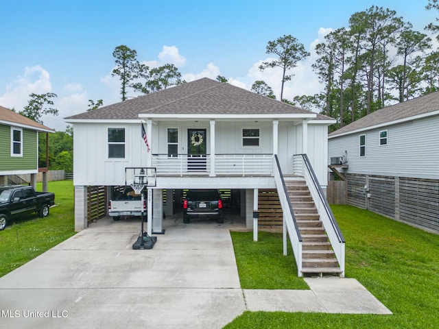 3927 Washington Ave, Gulfport, MS 39507 - beach home featuring a carport, board and batten siding, roof with shingles, stairs, and concrete driveway