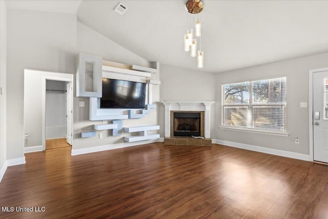 unfurnished living room featuring high vaulted ceiling, dark wood-type flooring, and a fireplace