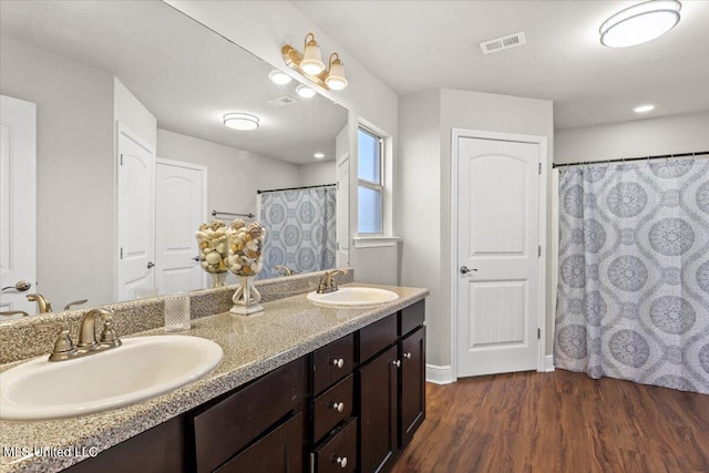 bathroom featuring vanity and hardwood / wood-style floors