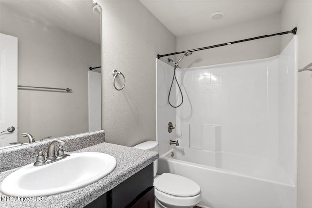 full bathroom featuring bathtub / shower combination, vanity, and toilet