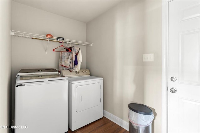 clothes washing area featuring separate washer and dryer and dark wood-type flooring