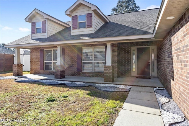 property entrance featuring a patio and a yard