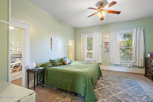 bedroom featuring ceiling fan and carpet