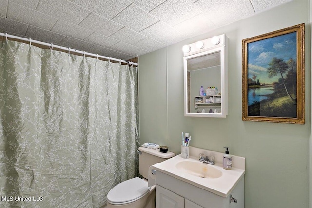 bathroom featuring vanity, curtained shower, and toilet