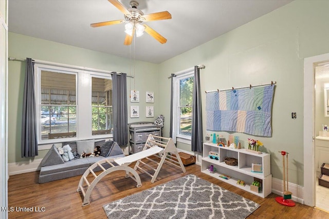 sitting room featuring ceiling fan and wood-type flooring