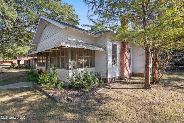 view of property exterior with a yard