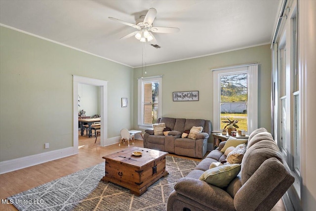 living room with crown molding, hardwood / wood-style flooring, and ceiling fan