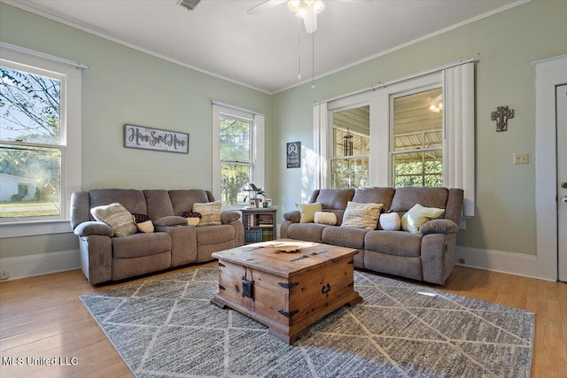 living room featuring crown molding, hardwood / wood-style flooring, and ceiling fan