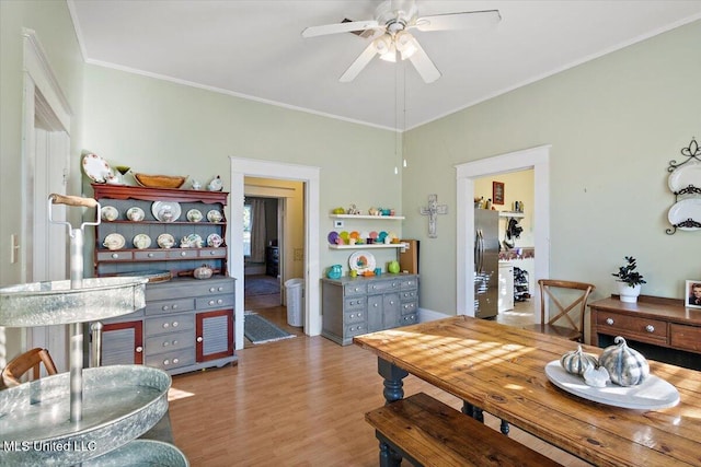 dining space featuring ornamental molding, light hardwood / wood-style floors, and ceiling fan