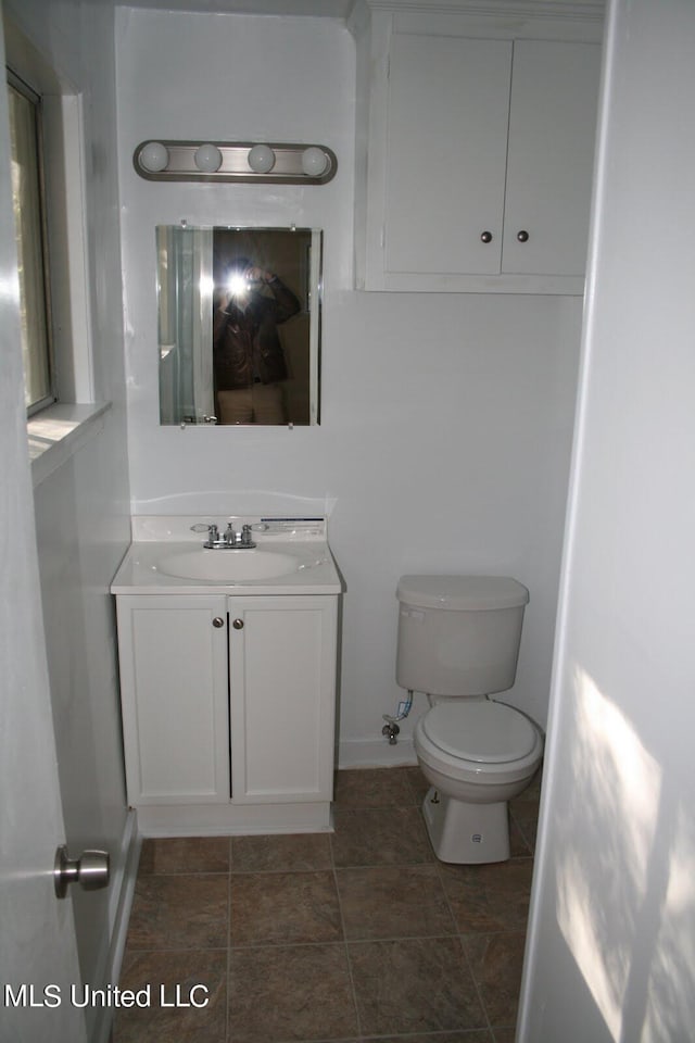 bathroom featuring vanity, toilet, and tile patterned floors