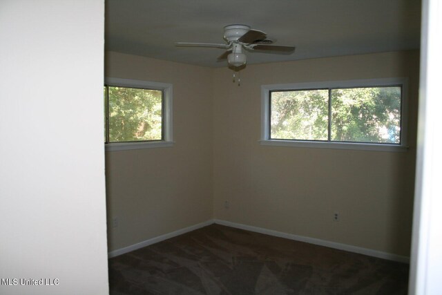 carpeted spare room with ceiling fan