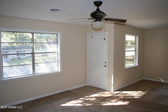 interior space with ceiling fan and carpet flooring