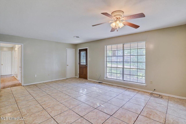 338 Lake Of Pines Dr, Jackson, MS 39206 - empty room with light tile patterned floors, baseboards, and a ceiling fan